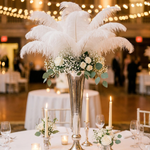 Tall ostrich feather centerpiece in a silver trumpet vase, styled table setting